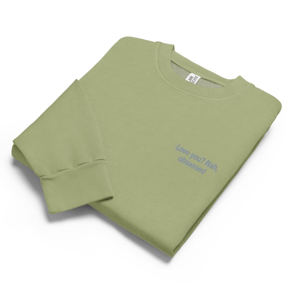 Folded green sweatshirt with text on a white background