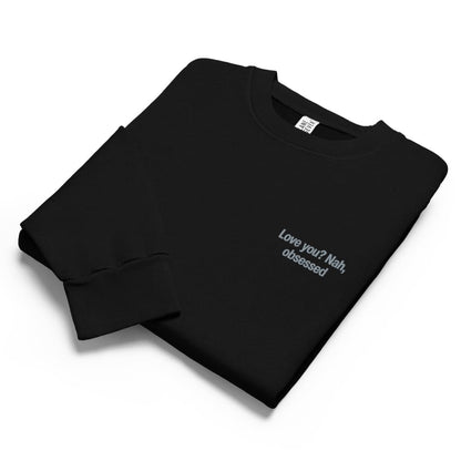Black sweatshirt with text 'Love you? Nah, obsessed' on a white background