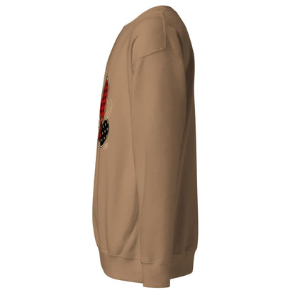 Tan sweatshirt with a patch on the sleeve against a white background