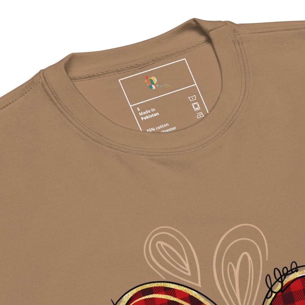 Close-up of a brown t-shirt with a brand label and graphic design.