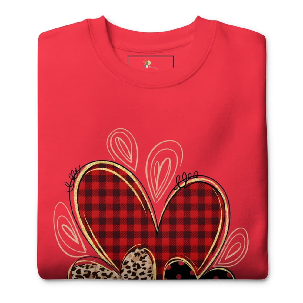 Folded red shirt with plaid heart design on a white background
