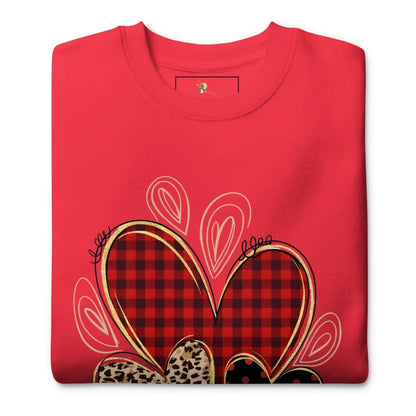 Folded red shirt with plaid heart design on a white background