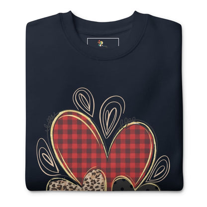 Folded navy blue sweatshirt with a red plaid heart design on a white background