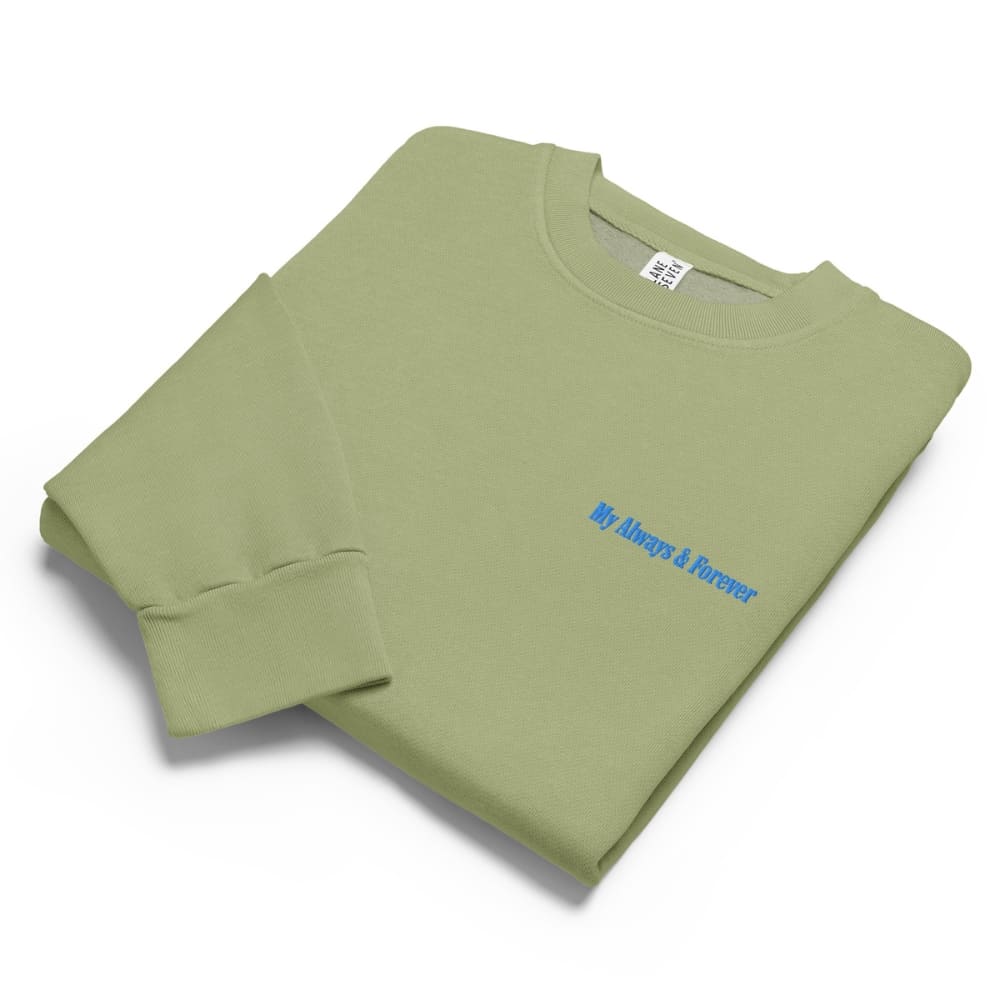 Folded green sweatshirt with blue text on a white background