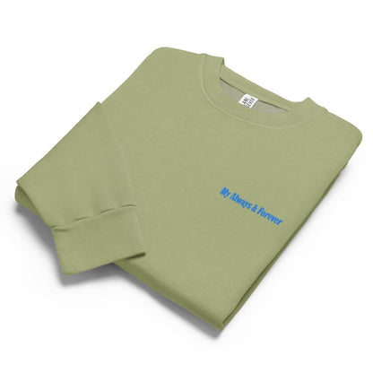 Folded green sweatshirt with blue text on a white background