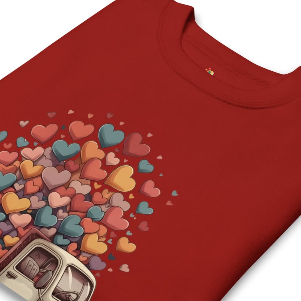 Red t-shirt with colorful heart design and a can of soda on a white background