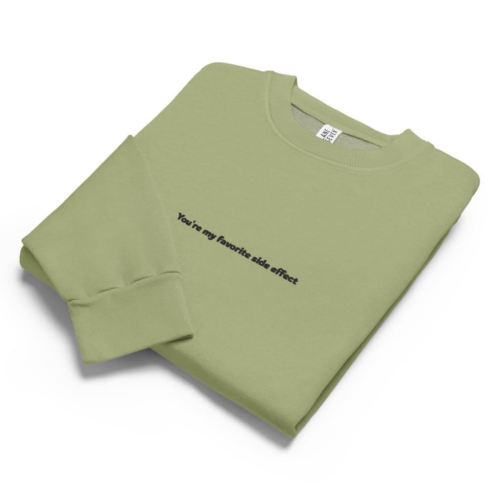 Folded green sweatshirt with text on a white background