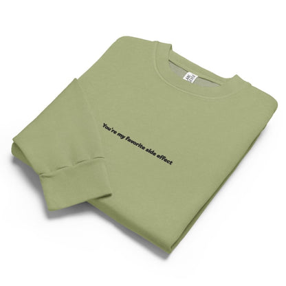 Folded green sweatshirt with text on a white background