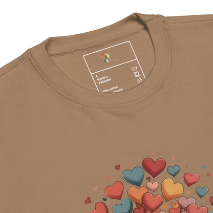 Brown t-shirt with colorful heart designs and a brand label on the collar.