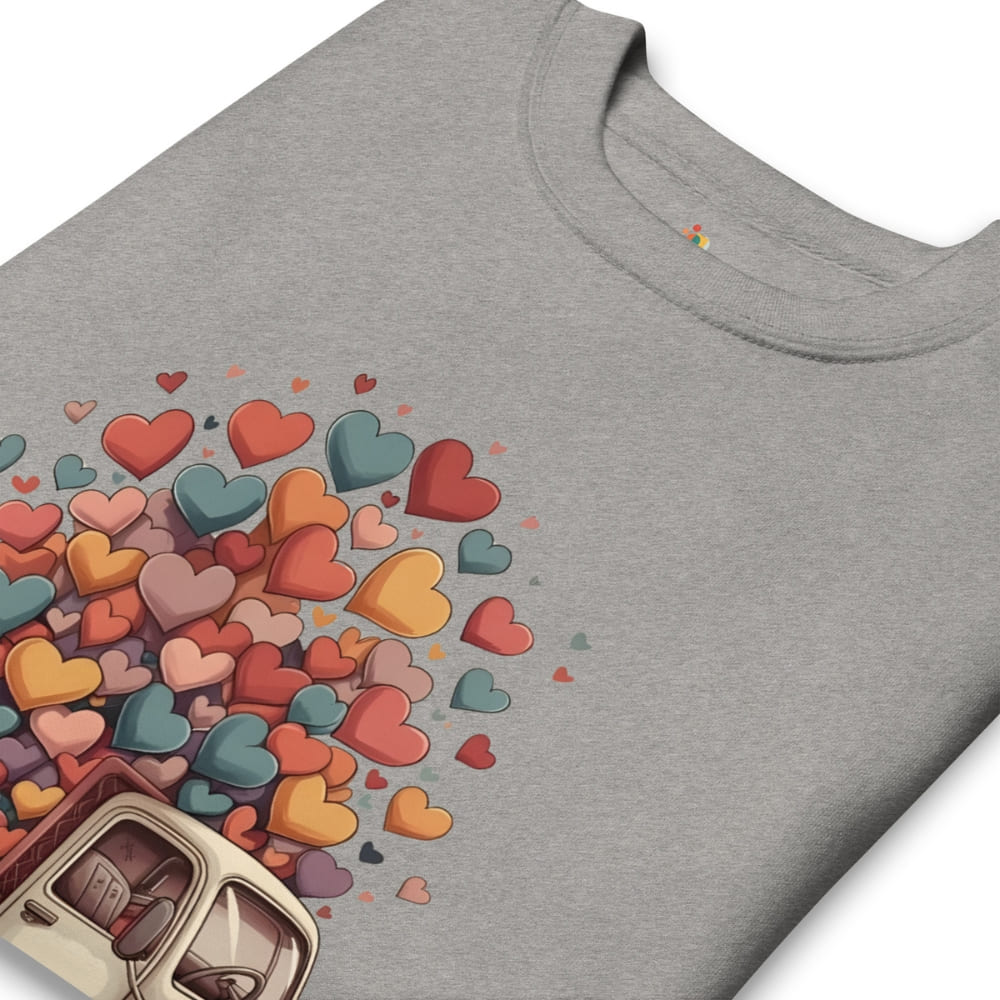 Gray t-shirt with colorful heart design and can opener on a white background