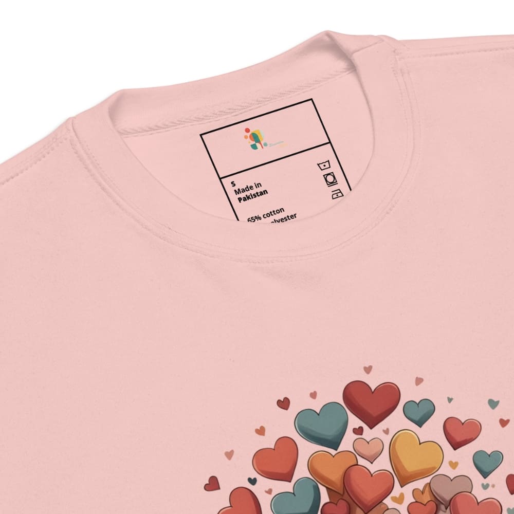 Pink t-shirt with colorful heart pattern and brand label on a white background