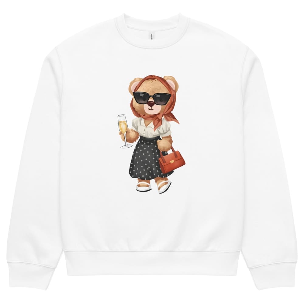 White sweatshirt with a teddy bear design holding a glass of champagne and a handbag on a white background