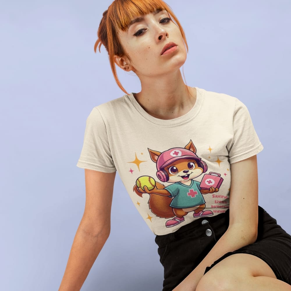 Cute squirrel nurse cartoon in scrubs, pink cap, and headset holding a softball and medical kit with the phrase “Saving Lives Between Innings” — printed on a heavyweight cotton t-shirt