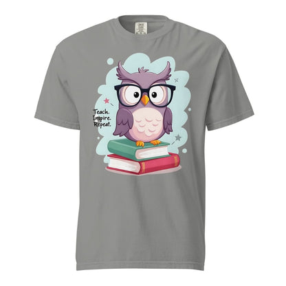 Cute purple owl with glasses sitting on stacked books, with quote "Teach. Inspire. Repeat." – printed on a teacher t-shirt