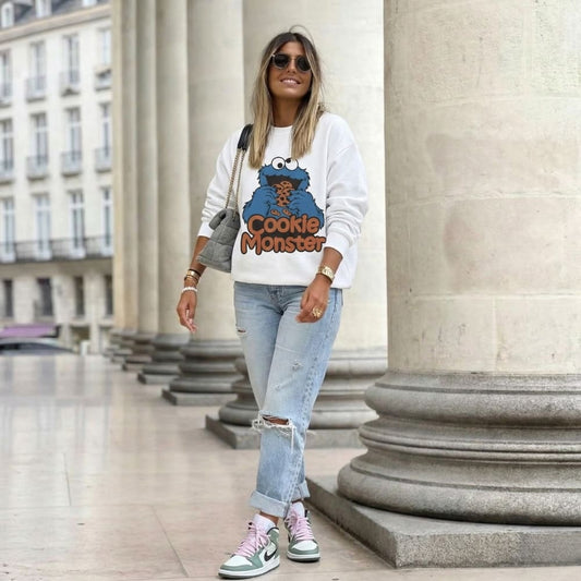 Woman wearing a Cookie Monster sweatshirt in an urban setting