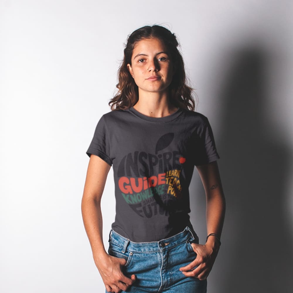 Person wearing a dark gray t-shirt with colorful text design on a plain background