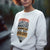 Person wearing a sweatshirt with a graphic and text