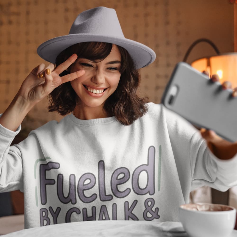 Fueled by Chalk & Dreams printed design on a vintage-style garment-dyed sweatshirt with chalkboard illustration – soft fleece ideal for teachers