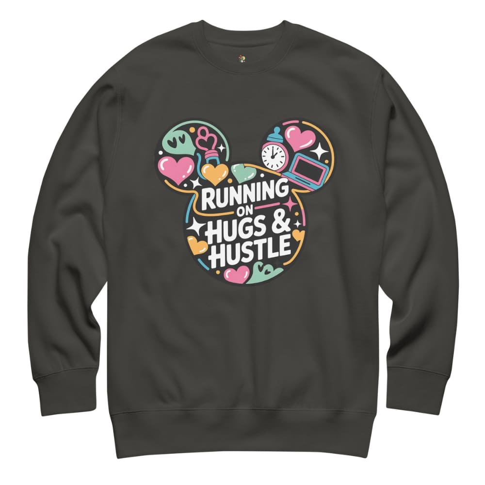 Black sweatshirt with colorful graphic and text 'Running on Hugs & Hustle' on a white background