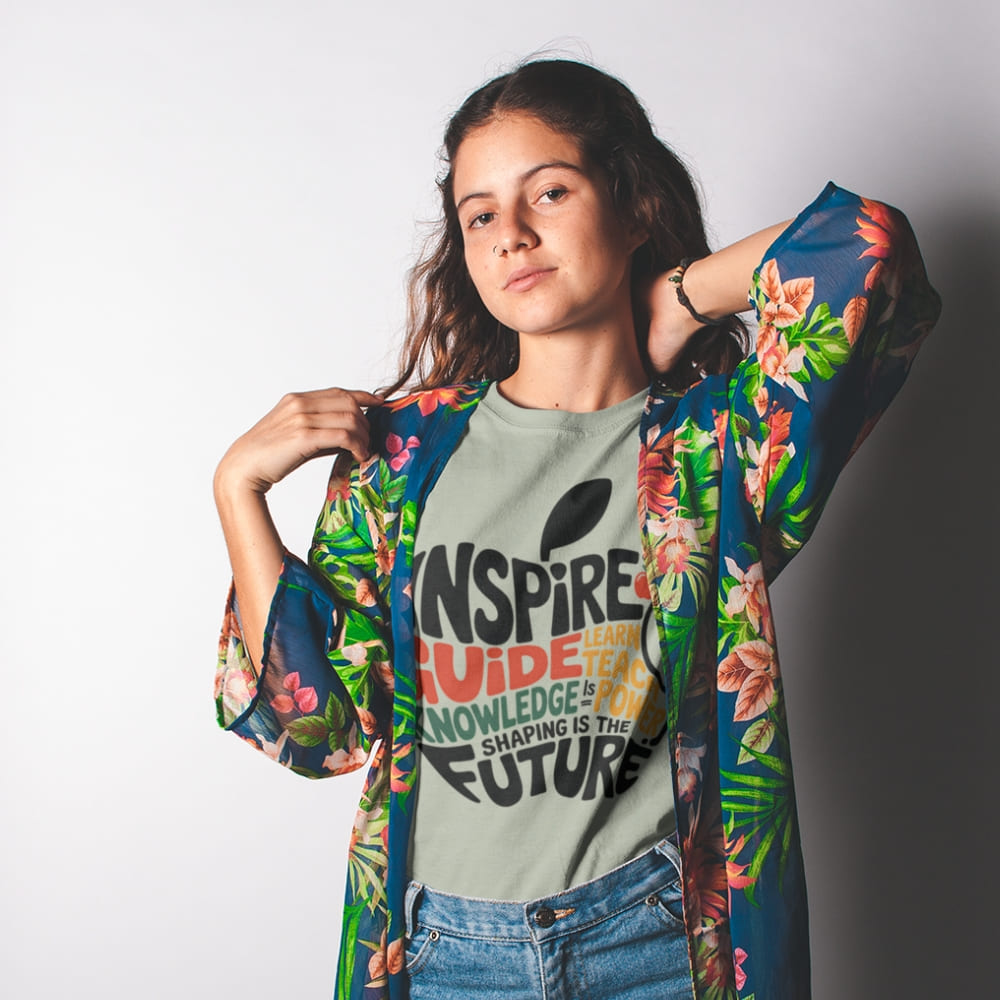 Woman wearing a floral kimono over a graphic t-shirt with text on a plain background