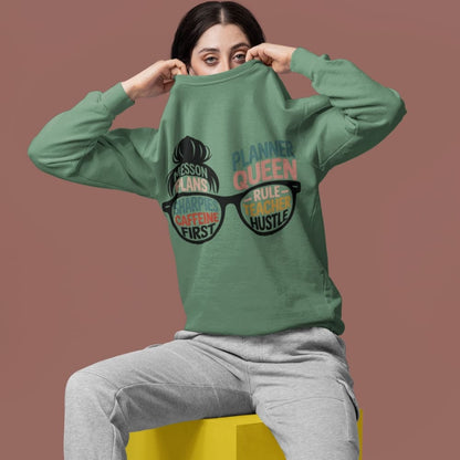 Person wearing a green sweatshirt with text and graphics on a brown background