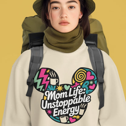 Person wearing a beige sweatshirt with colorful graphic and text, standing against a yellow background.