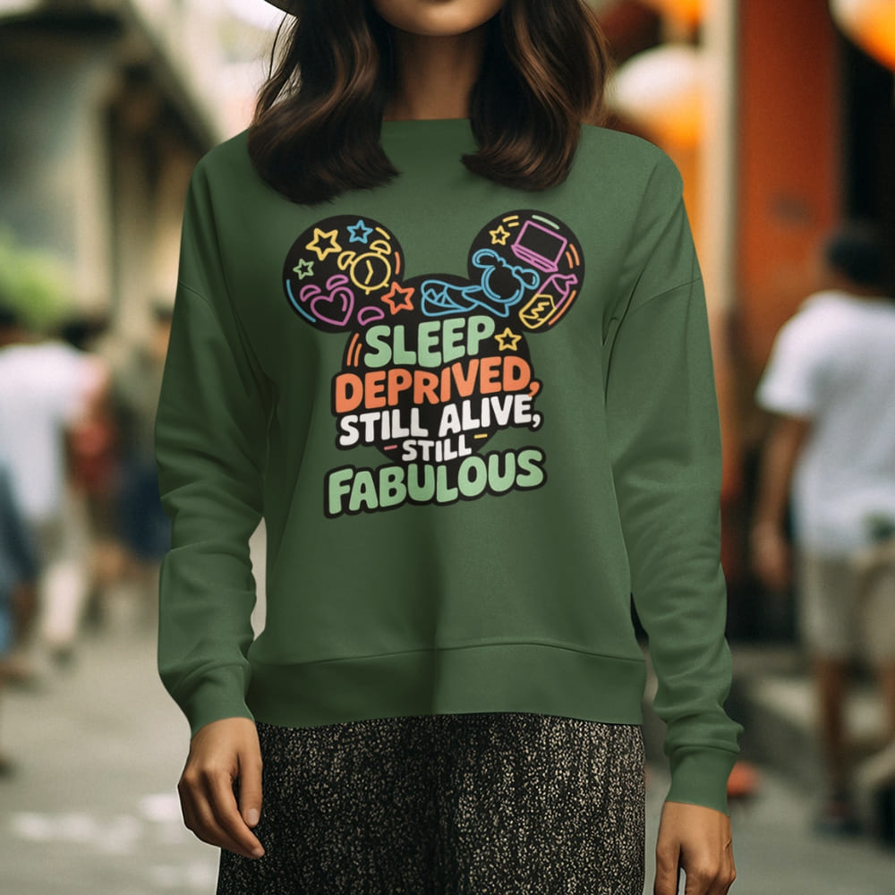 Person wearing a green sweatshirt with colorful text and graphics in an urban setting