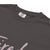 Garment-dyed relaxed fit t-shirt with motivational quote “Tired But Thriving” in modern handwritten script