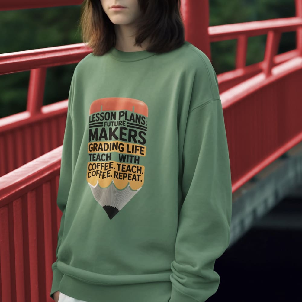 Person wearing a green sweatshirt with a graphic design in front of a red bridge.