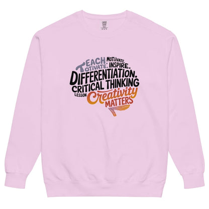 Pink sweatshirt with motivational text design on a white background