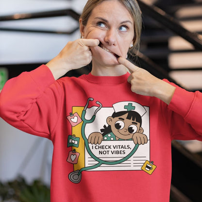 Person wearing a red sweatshirt with a graphic design and text, pointing to the design.