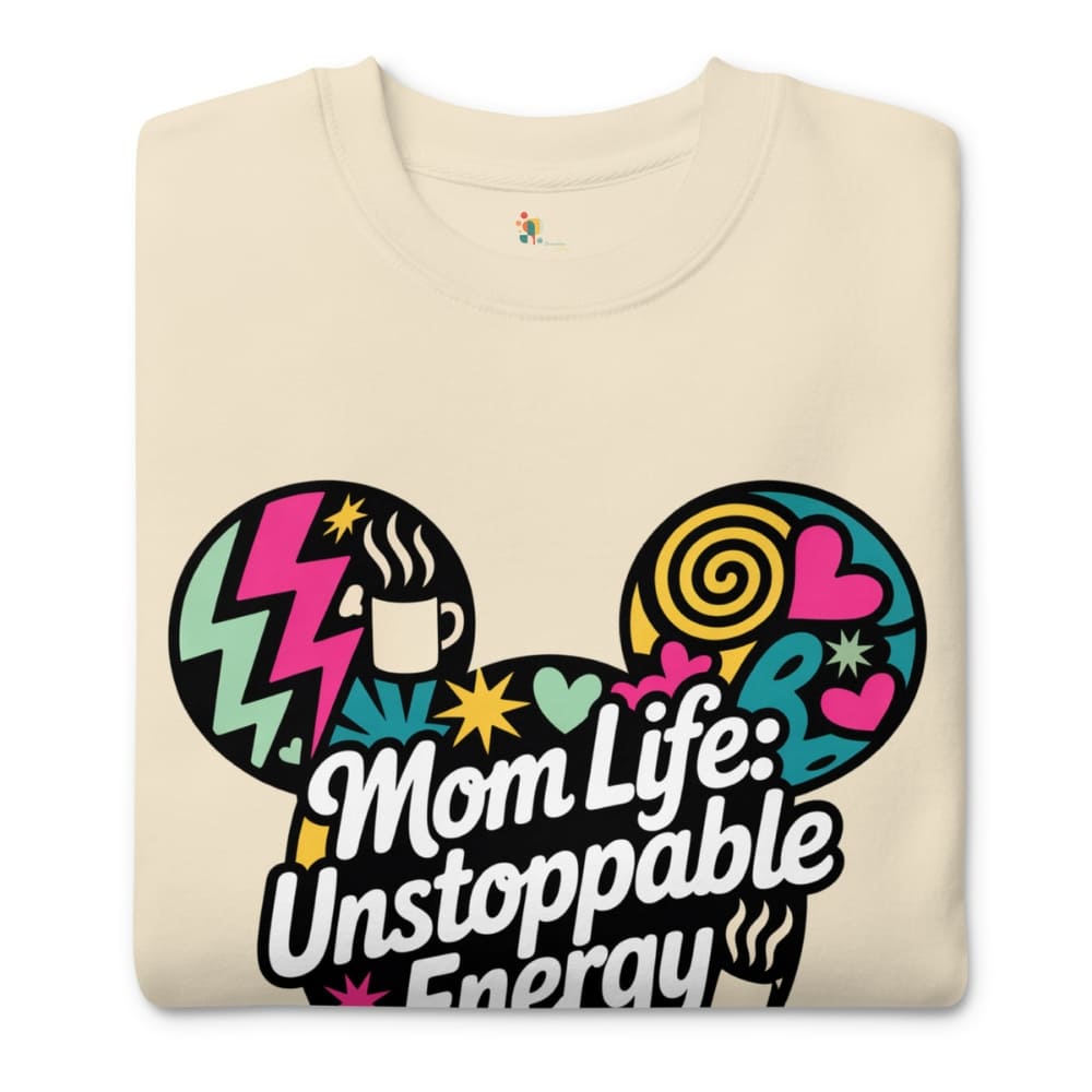 Beige t-shirt with colorful design and text 'Mom Life: Unstoppable Energy' on a white background