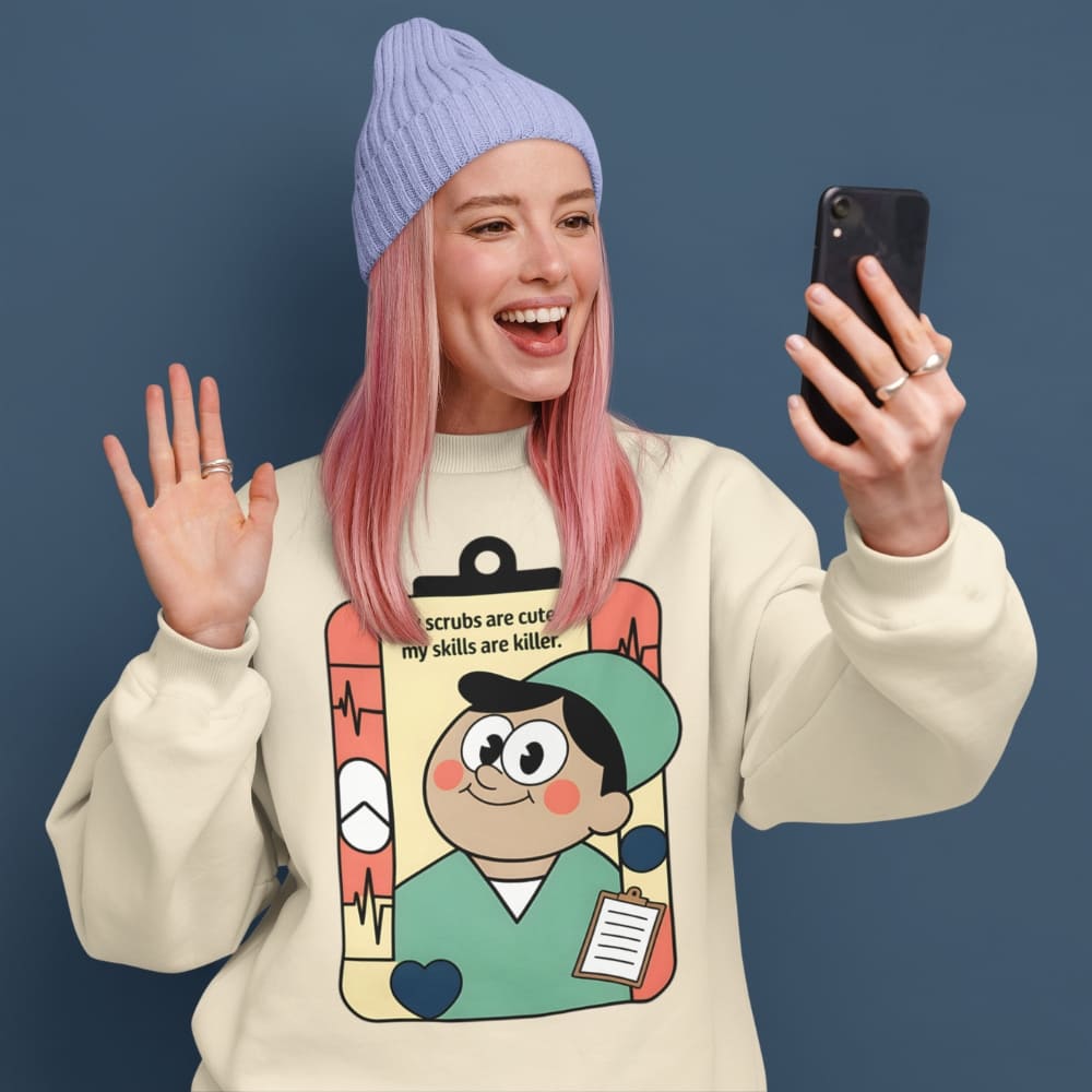 Person wearing a beige sweatshirt with a cartoon character design, holding a phone, and waving against a dark blue background.