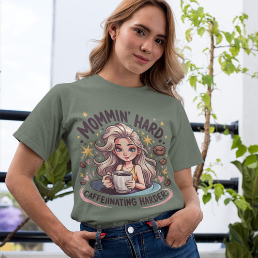 Woman wearing a t-shirt with a graphic design and text, standing indoors with plants in the background.