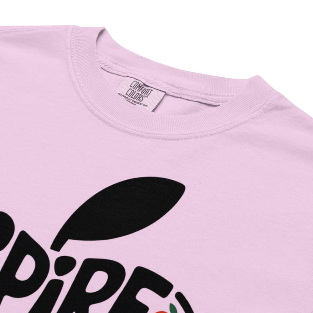 Pink t-shirt with black text and leaf design, brand label visible.