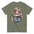 Olive green t-shirt with a graphic of a nurse holding a sign saying 'I give shots for a living, test me.'