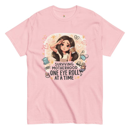 Pink t-shirt with a graphic of a woman and text 'Surviving Motherhood One Eye Roll at a Time' on a white background.
