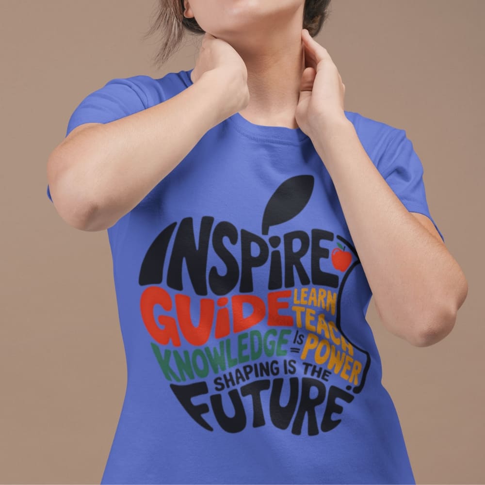Person wearing a blue t-shirt with motivational text on a beige background