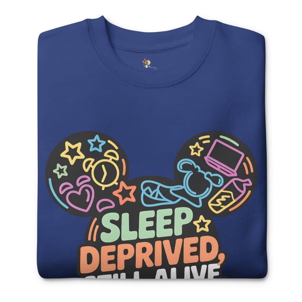 Blue sweatshirt with colorful graphic design and text 'Sleep Deprived, Still Alive' on a white background