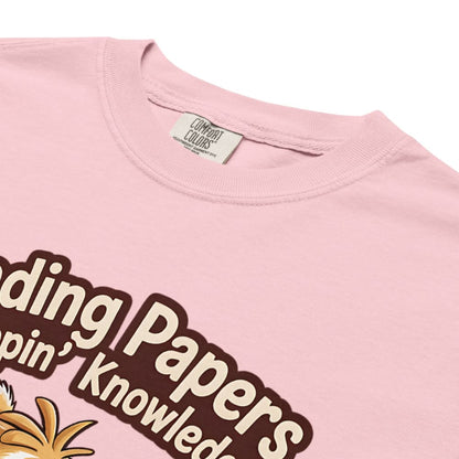 Pink t-shirt with text and a pineapple graphic, brand label visible.