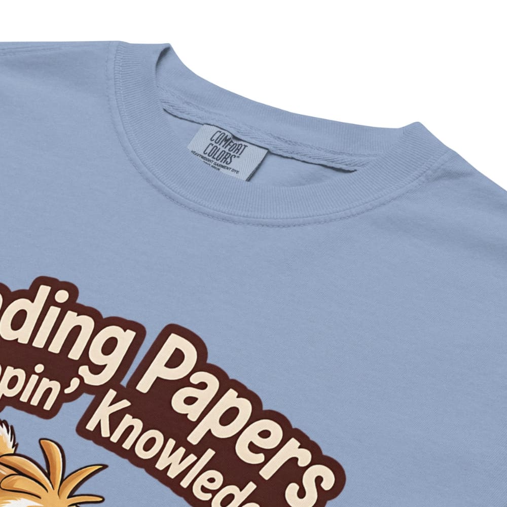 Light blue t-shirt with brown text and a pineapple graphic on a white background