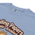 Light blue t-shirt with brown text and a pineapple graphic on a white background