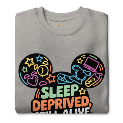 Gray sweatshirt with colorful graphic design and text 'Sleep Deprived, Still Alive' on a white background