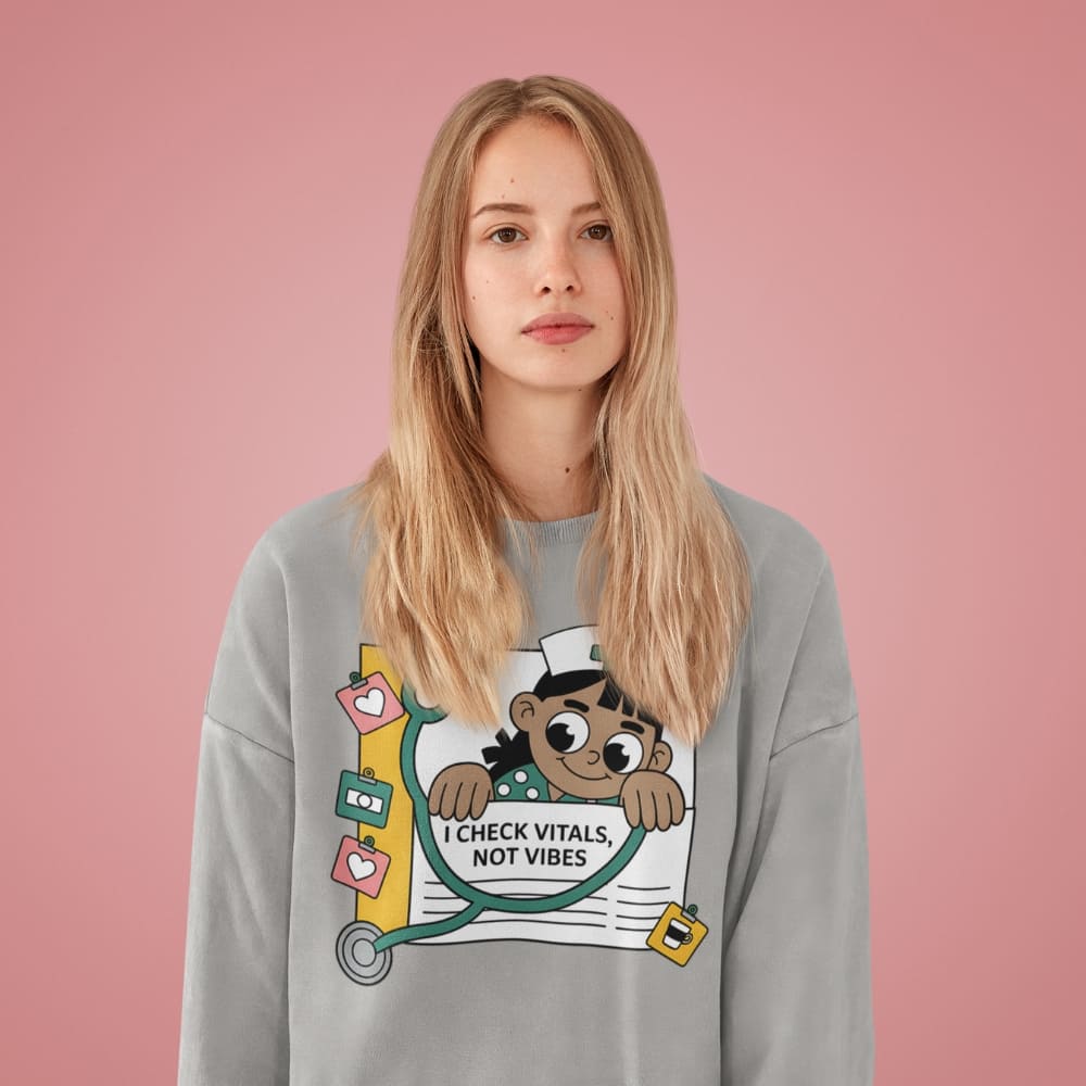 Person wearing a gray sweatshirt with a graphic design on a pink background