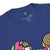 Close-up of a blue t-shirt with colorful graphics and a visible label on the collar.