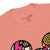 Pink t-shirt with colorful graphics and text on a white background