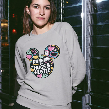 Person wearing a gray sweatshirt with colorful graphic design and text.