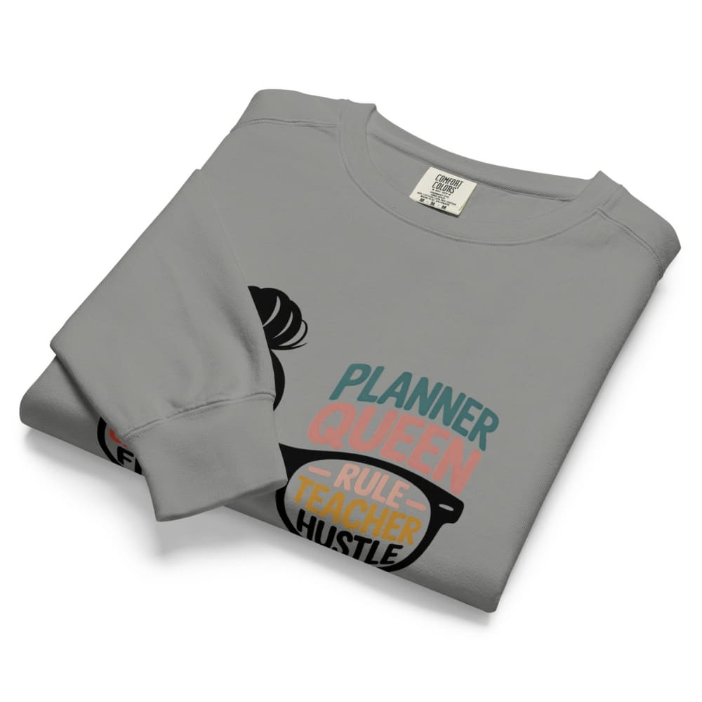 Folded gray sweatshirt with text design on a white background