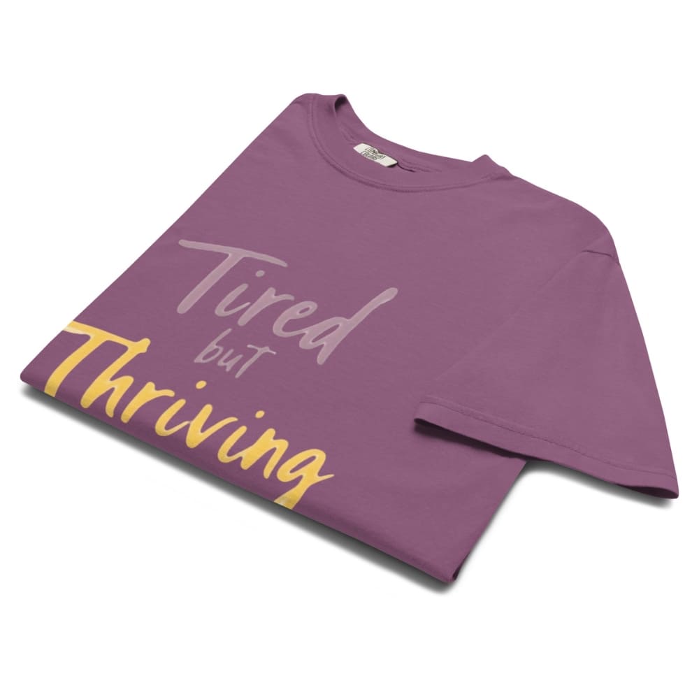 Garment-dyed relaxed fit t-shirt with motivational quote “Tired But Thriving” in modern handwritten script