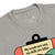 Gray t-shirt with a graphic design and text on a white background